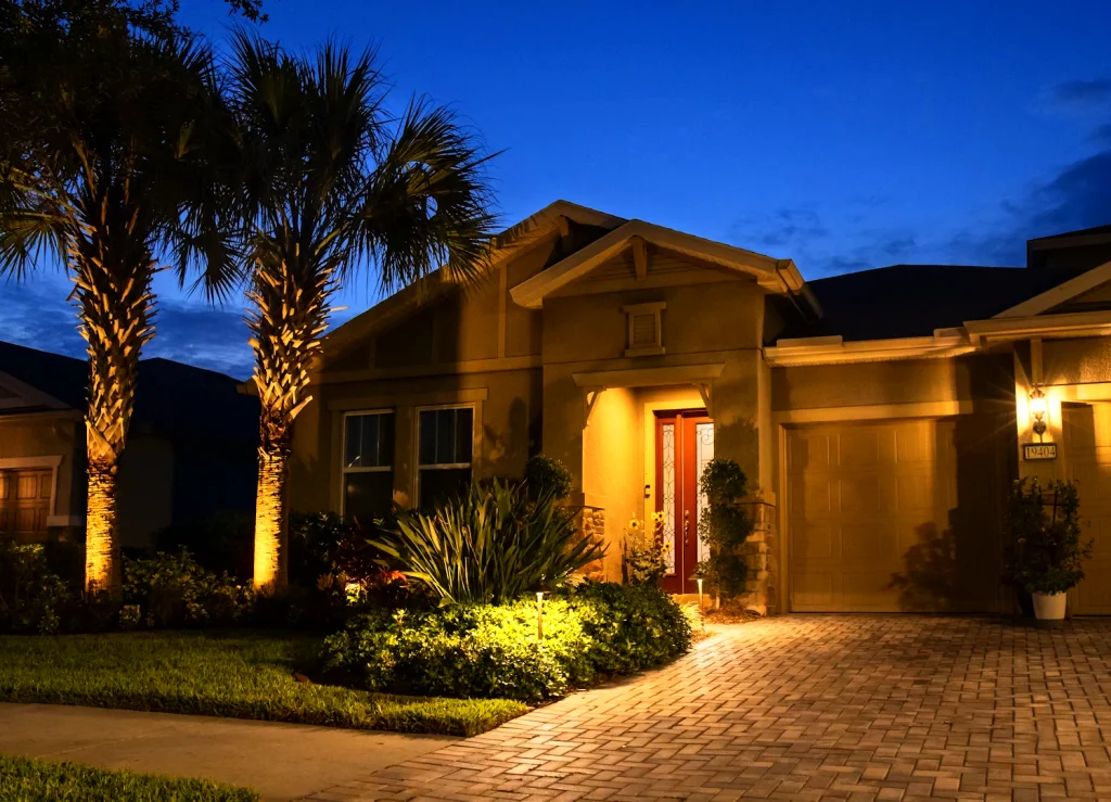 Beautifully lit home exterior at dusk, with palm trees
