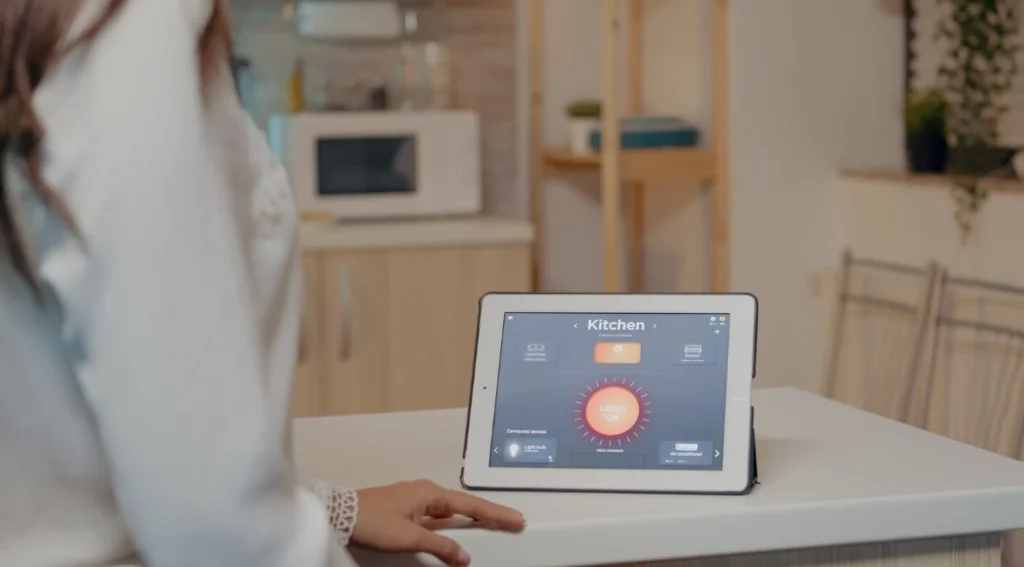 Controlling smart lighting and devices in the kitchen using a tablet.