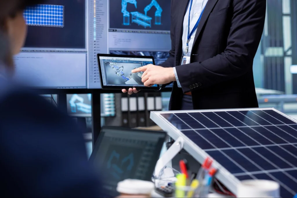 Professional discussing solar panel integration with energy management software.